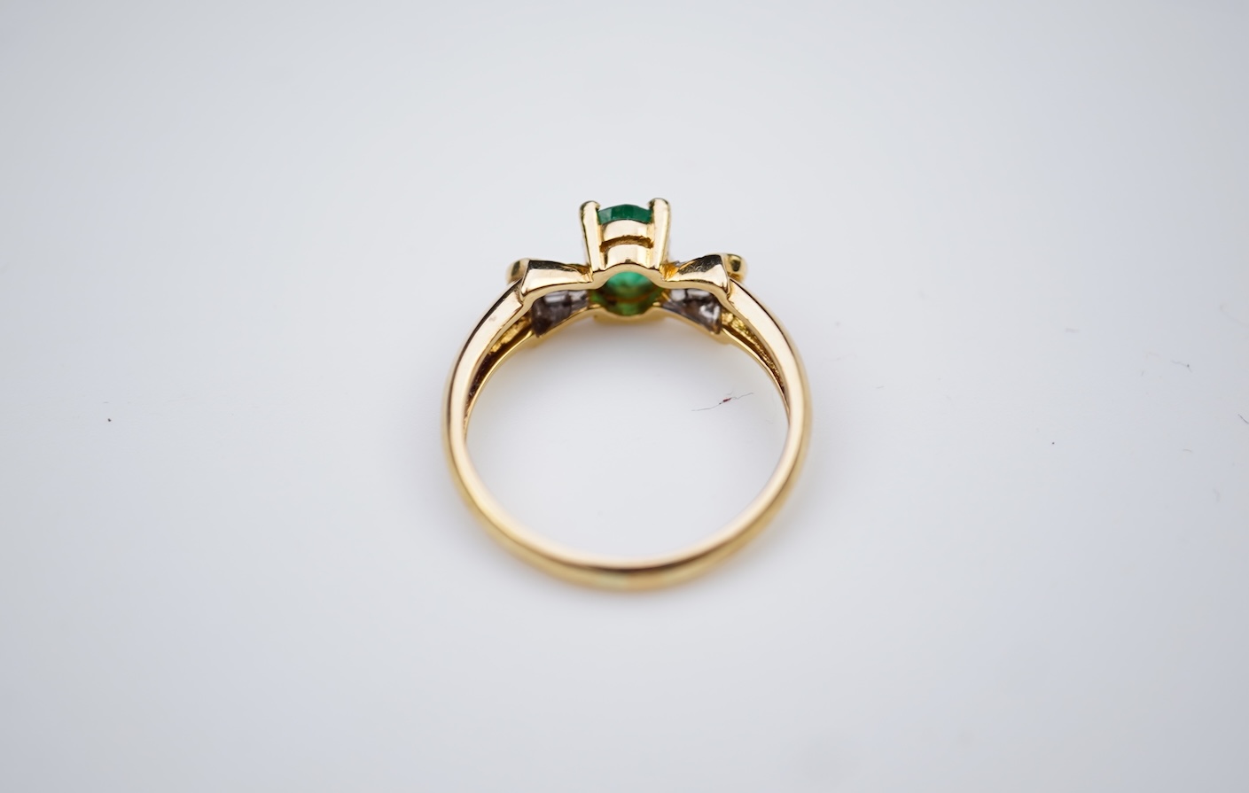 An emerald and diamond ring